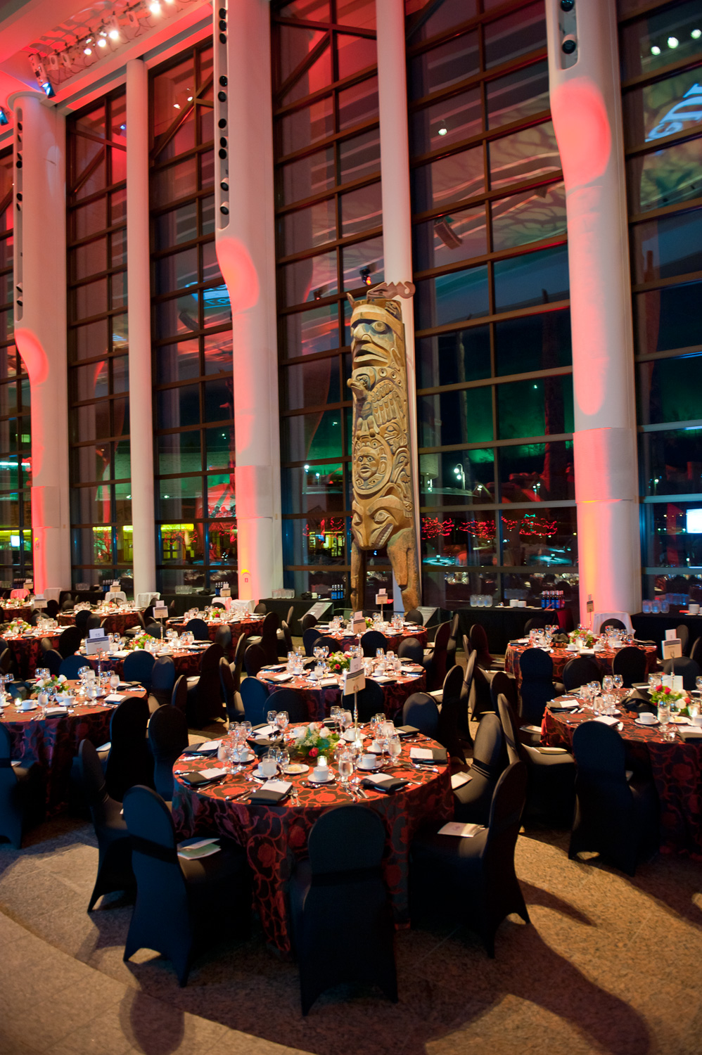 Room set up with tables and large windows in the building.