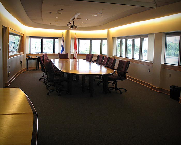 A conference room with facility rental options, featuring a long table and chairs.