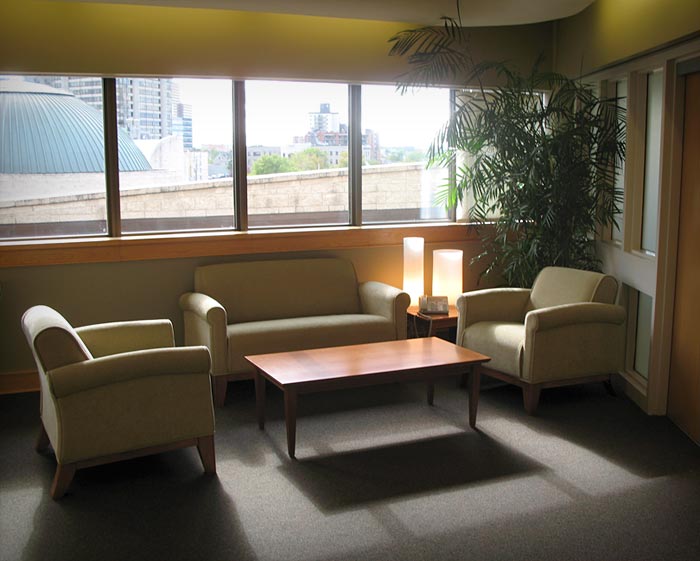 An executive boardroom furnished with couches and a coffee table.