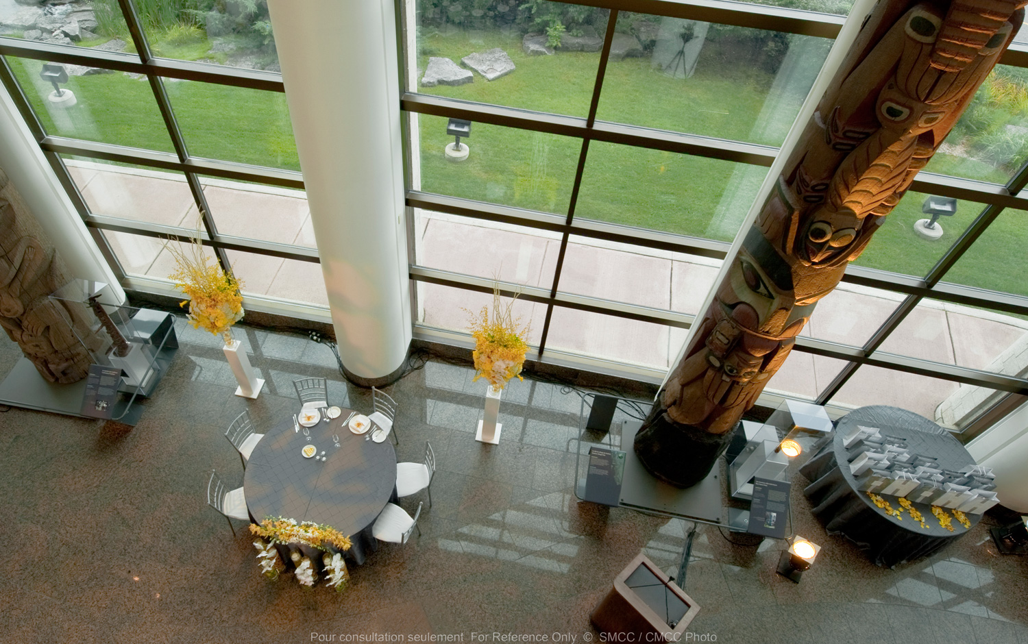 An aerial view of a dining room with large windows during a Haida Gwaii Salon Celebration.