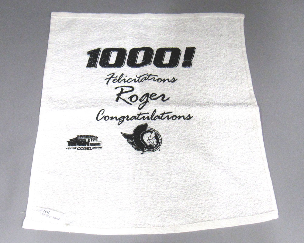 Roger Neilson inspired Vancouver’s towel-waving ritual. Neilson finished his career as assistant coach of the Ottawa Senators. The team made him interim head coach for the final two games of the 2002 NHL season, so he could reach the 1,000-game mark as a head coach. They issued these towels to mark the occasion. Neilson died in 2003. Towel on loan from the Peterborough & District Sports Hall of Fame. Photo: Canadian Museum of History. 