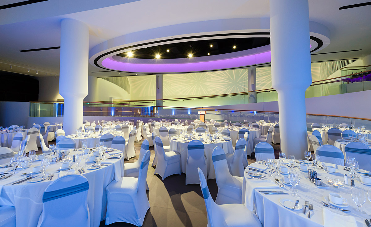 The Canadian Museum of History in Ottawa features a large room with white tables and chairs.