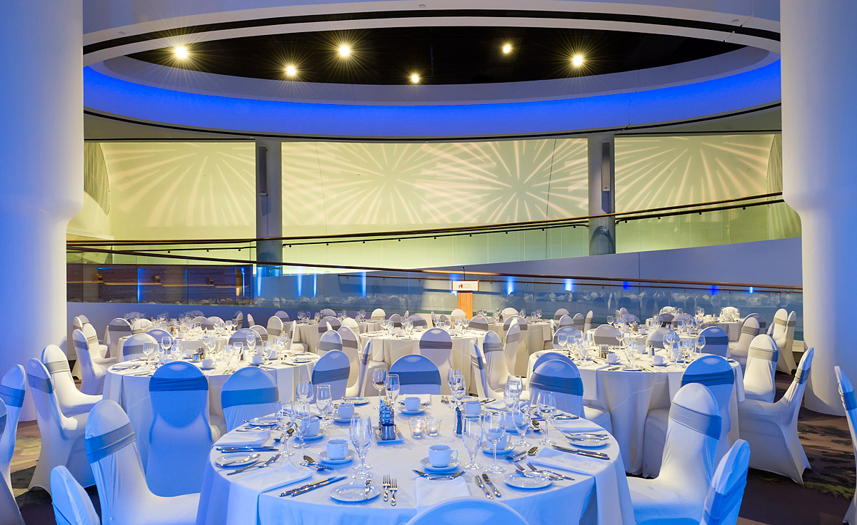 A circular room with white tables and chairs in the Canadian Museum of History.