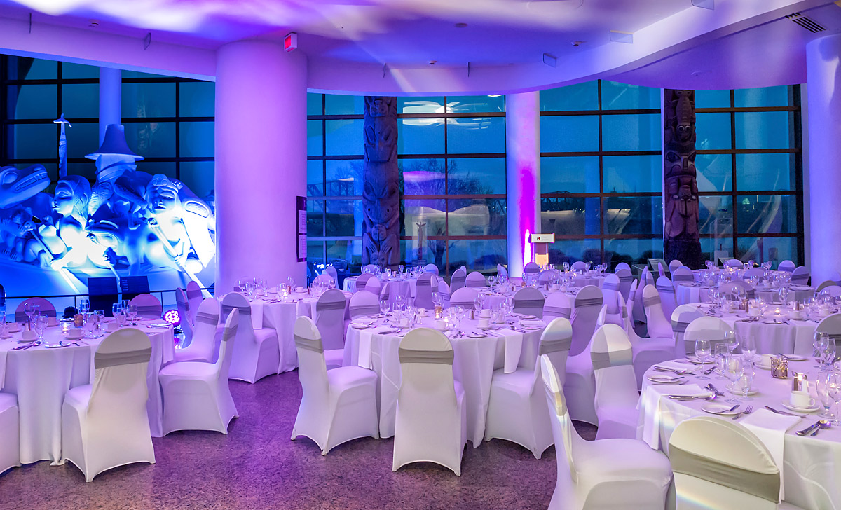 A wedding reception room at the Canadian Museum of History in Ottawa, with tables and chairs set up.