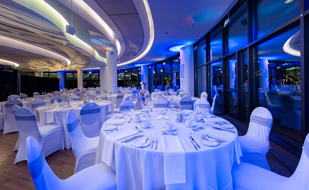 The Canadian Museum of History in Ottawa offers a stunning banquet hall with white tables and blue lights.