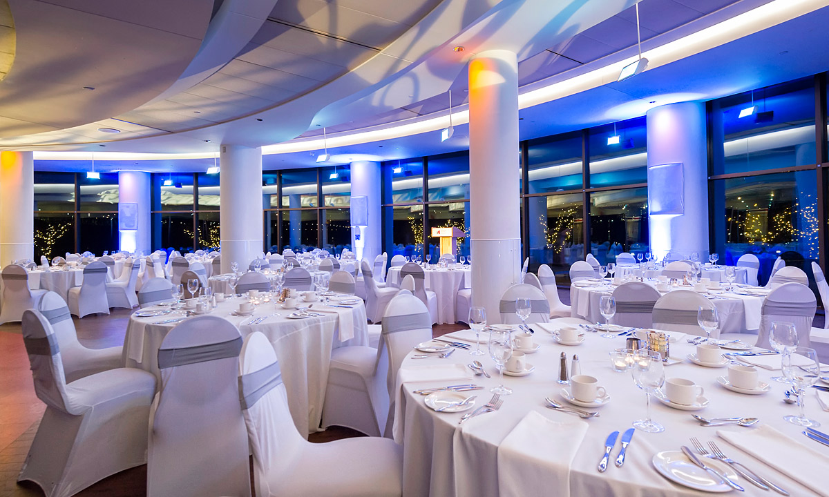 The Canadian Museum of History in Ottawa is home to a large banquet hall adorned with white tables and chairs.