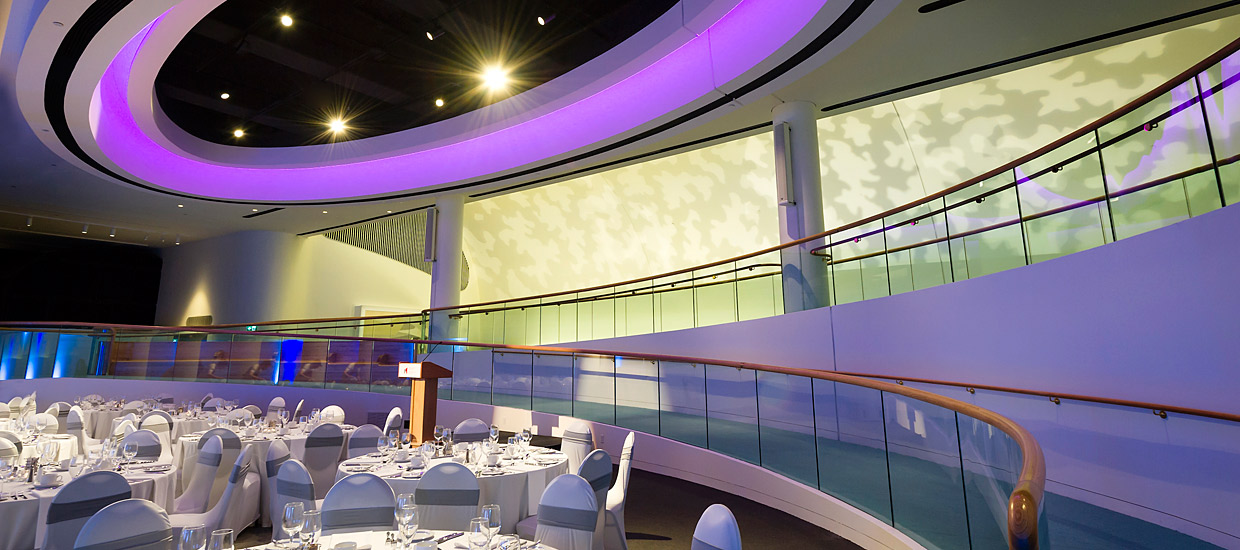 In Ottawa, the Canadian Museum of History houses a large room with a circular ceiling and white tables.