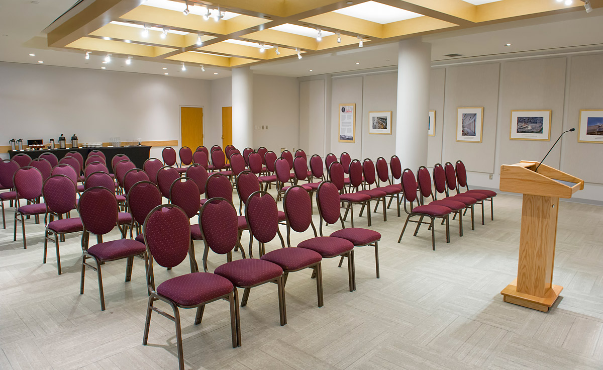 A room with rows of chairs and a podium located in Ottawa at the Canadian Museum of History.