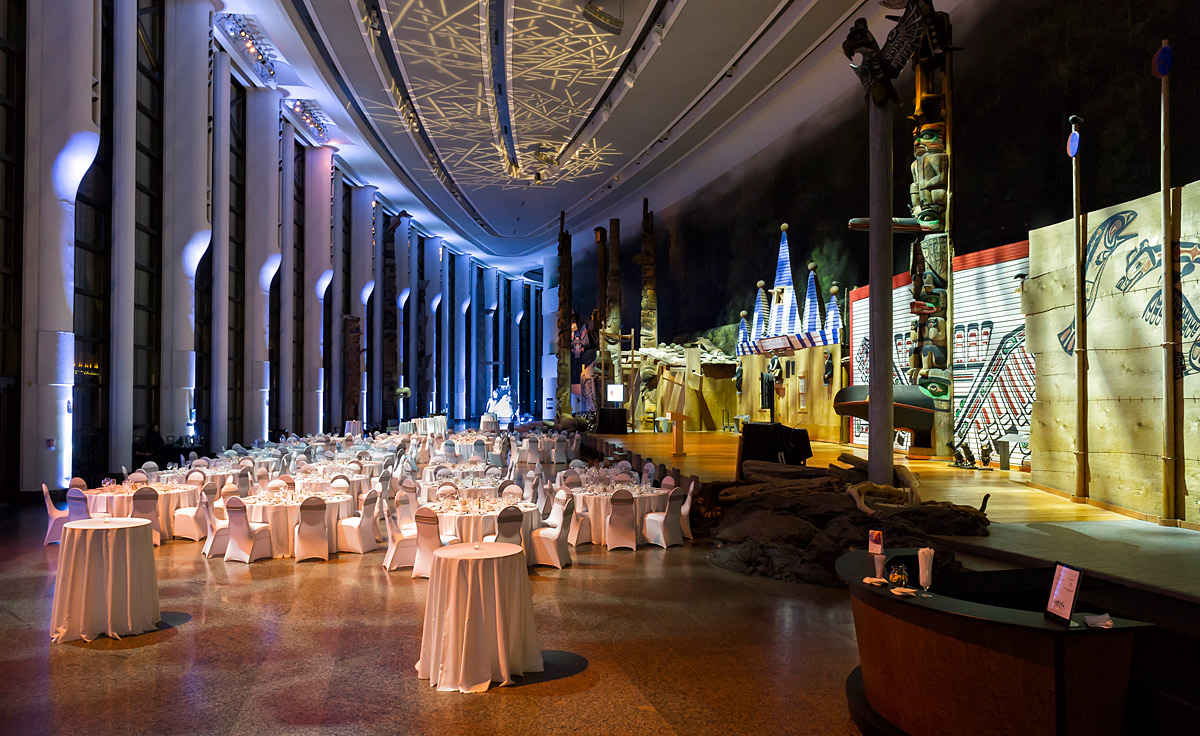 A large room with white tables and chairs in the Canadian Museum of History.