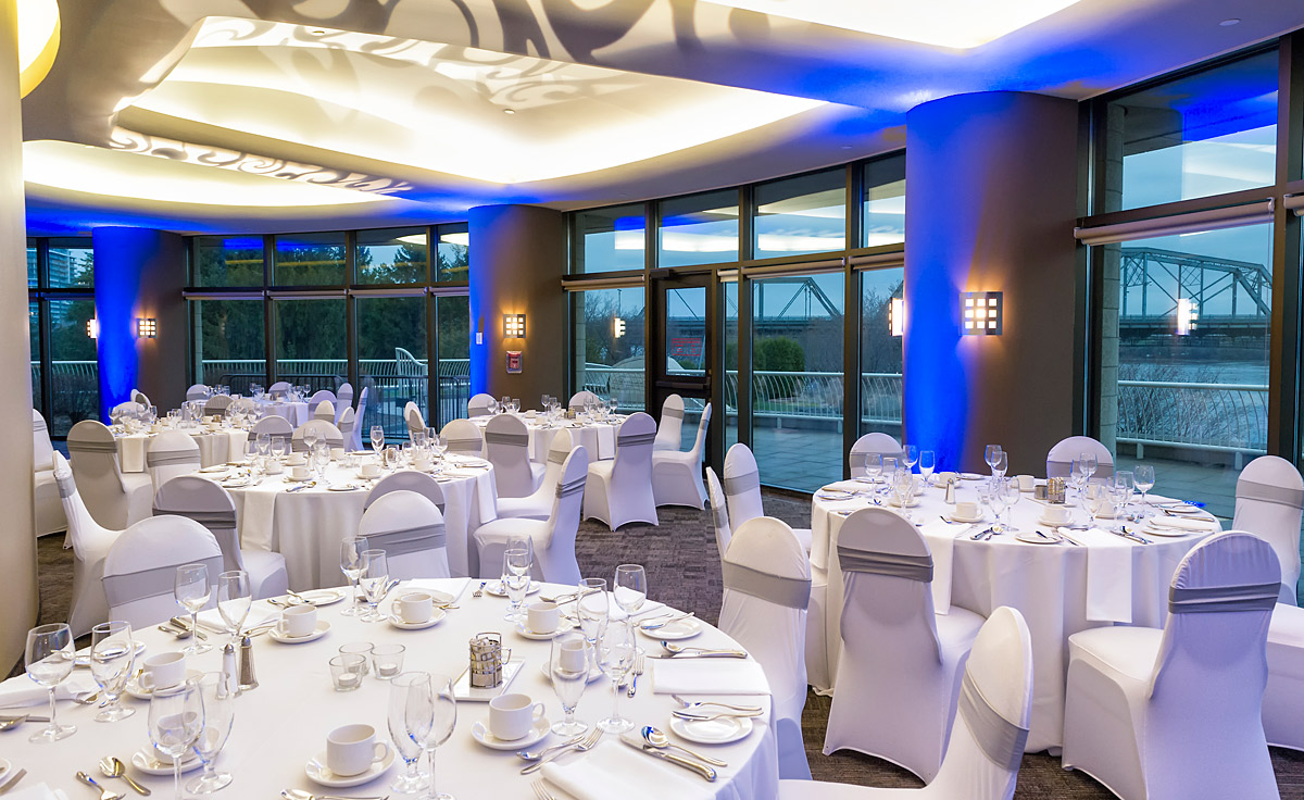 A large room with tables and chairs set up for a wedding at the Canadian Museum of History in Ottawa.