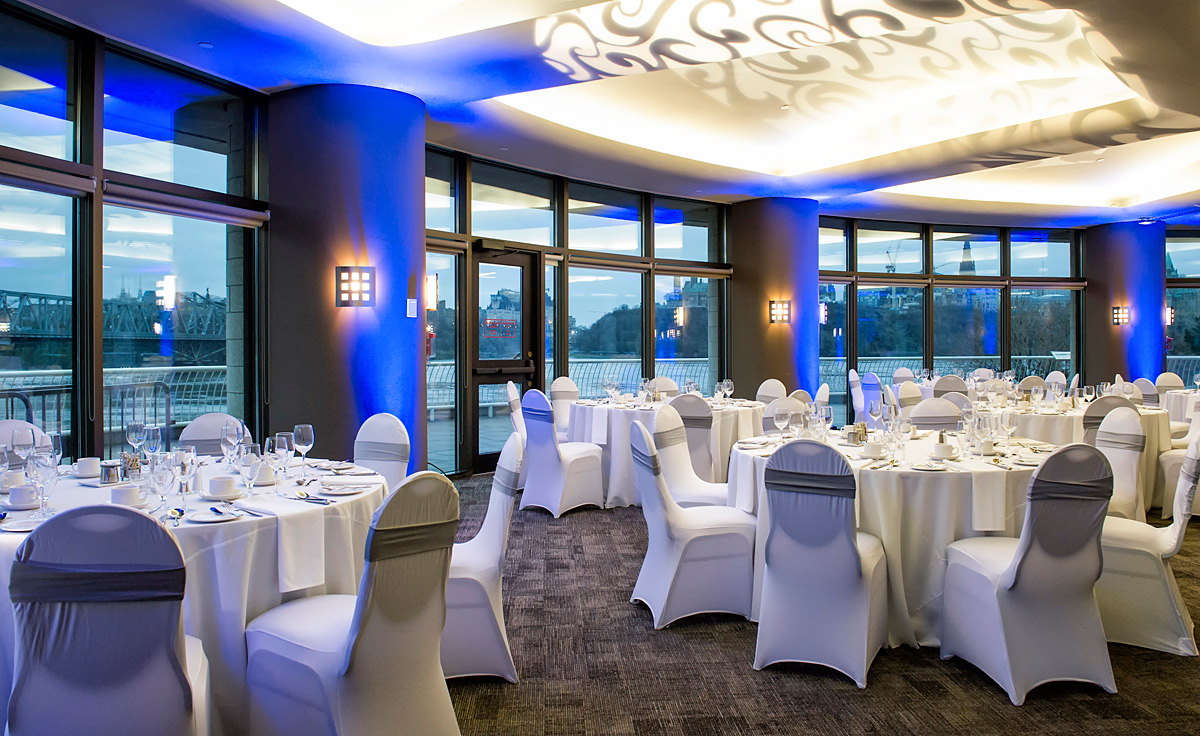 A large room with tables and chairs set up for a wedding at the Canadian Museum of History in Ottawa.