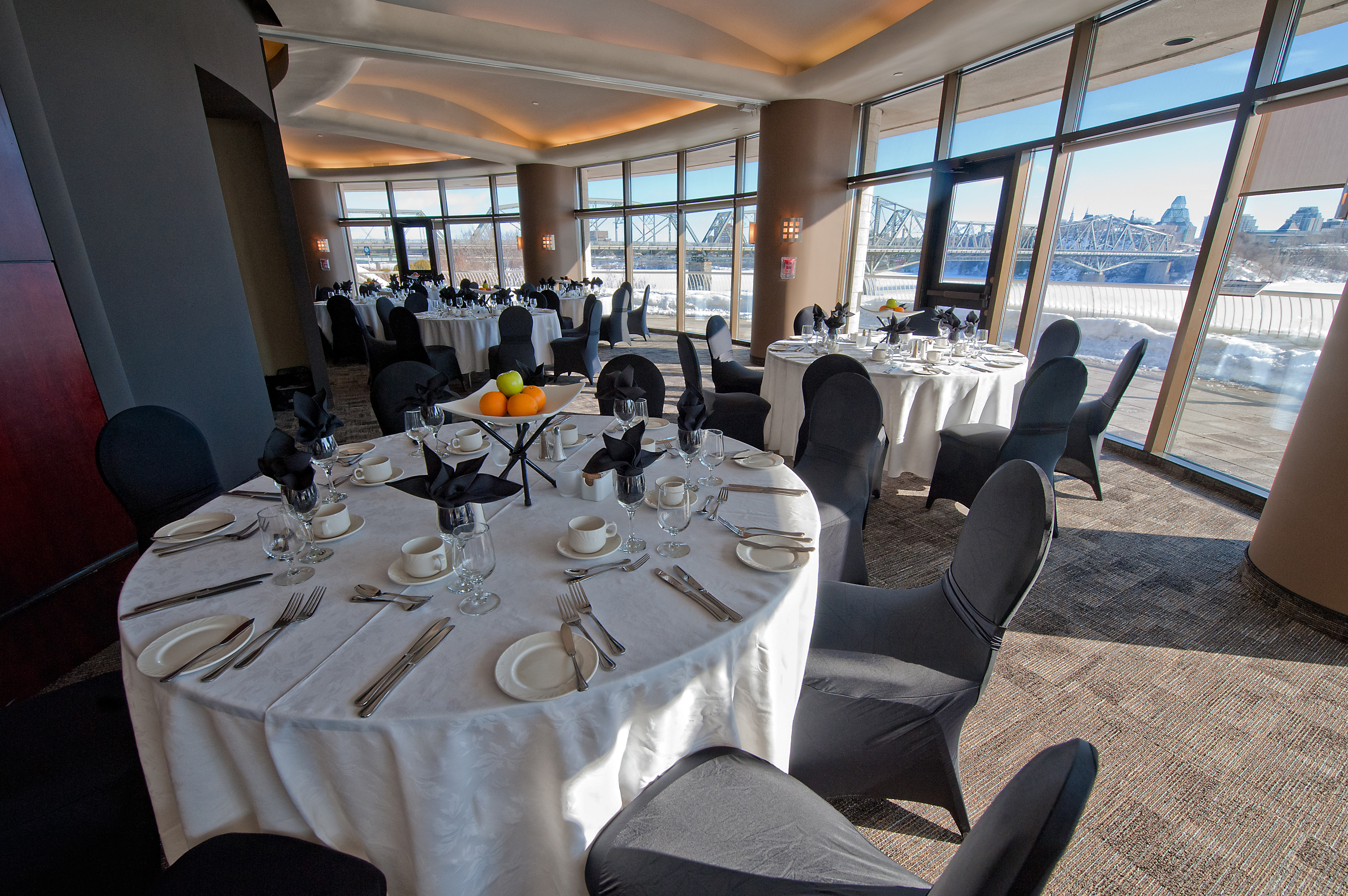 A room with tables and chairs set up in front of a large window at the Canadian Museum of History in Ottawa.