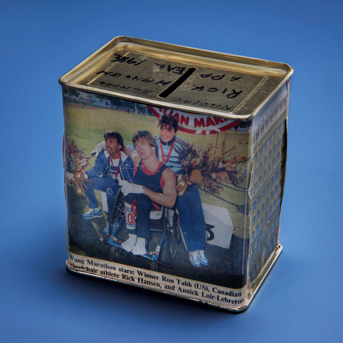 A tin box with a picture of two people in wheelchairs displayed at the Canadian Museum of History in Ottawa.