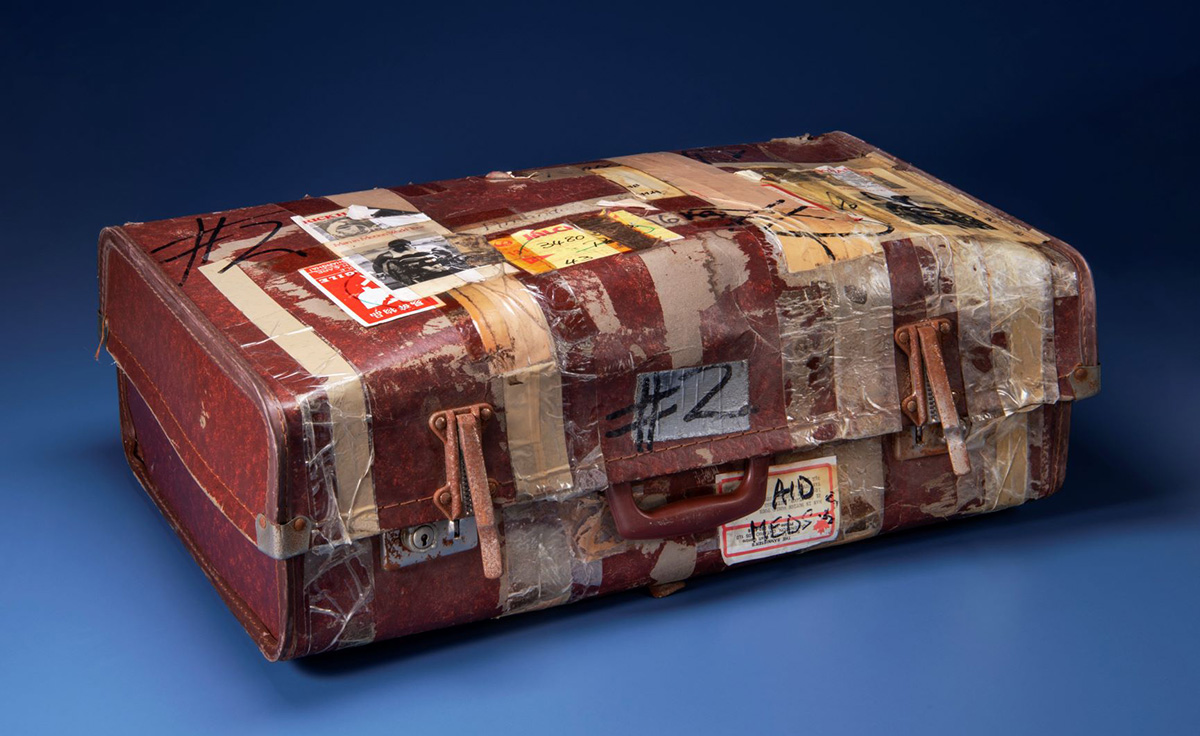 An old suitcase with stickers on it, displayed in the Canadian Museum of History in Ottawa.