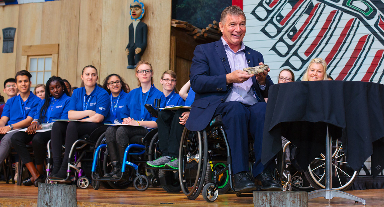 A group of people in wheelchairs sitting on a stage at the Canadian Museum of History in Ottawa.