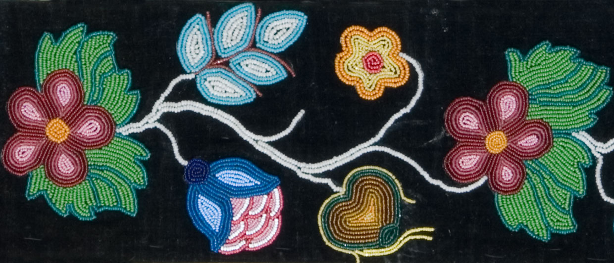 A colorful beadwork on a black background displayed at the Canadian Museum of History in Ottawa.