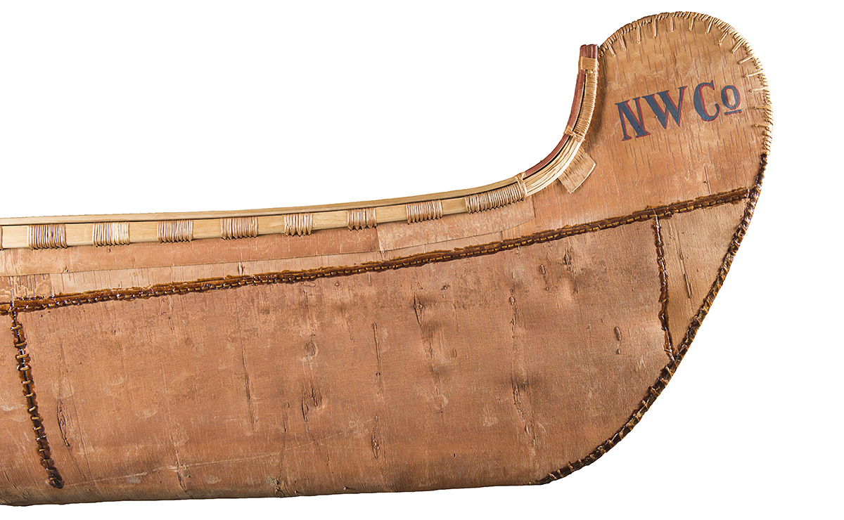 A wooden canoe with the word wwc on it, showcased at the Canadian Museum of History in Ottawa.