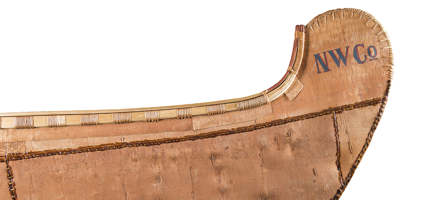 A wooden canoe with the word ww co on it, displayed at the Canadian Museum of History in Ottawa.