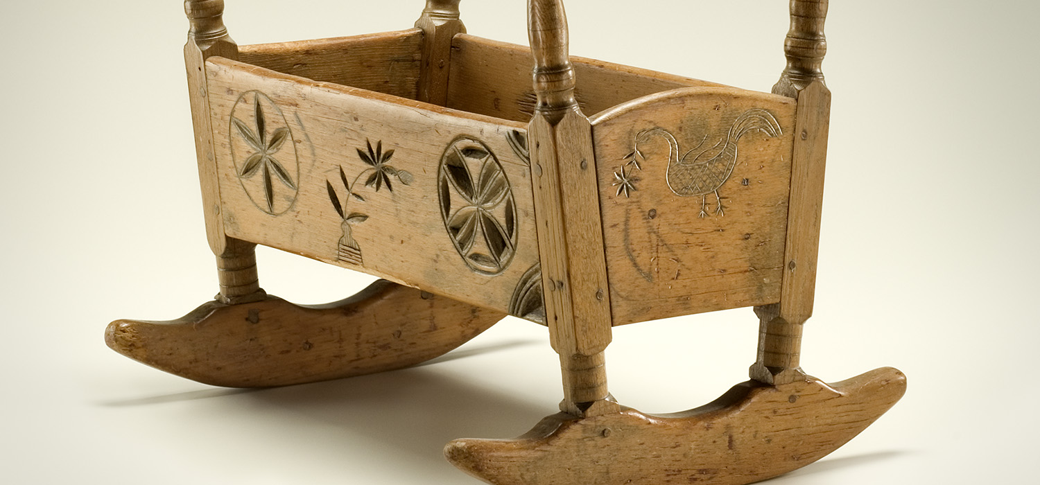 A wooden rocking chair with carvings on it is displayed at the Canadian Museum of History in Ottawa.