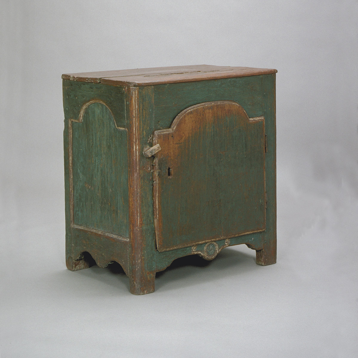 A small green cabinet with a wooden door, on display at the Canadian Museum of History in Ottawa.