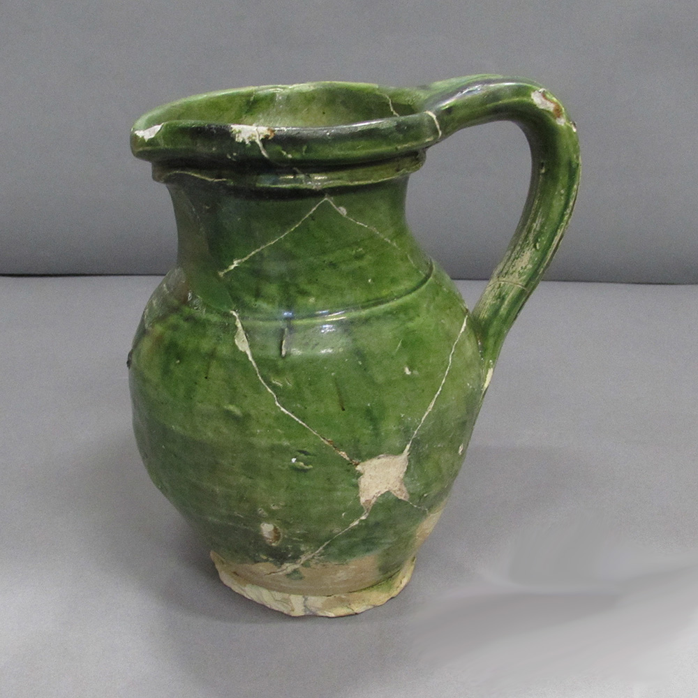 A green jug with a broken handle on display at the Canadian Museum of History in Ottawa.