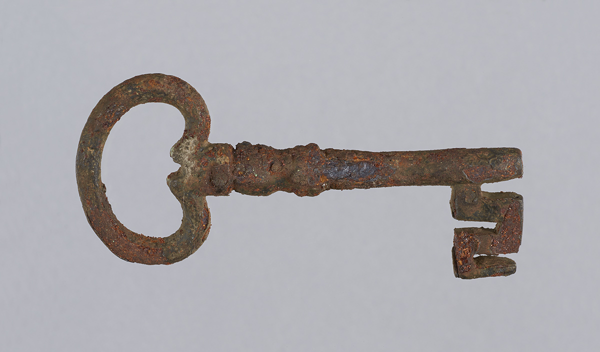 An old rusty key on a gray background in Ottawa.