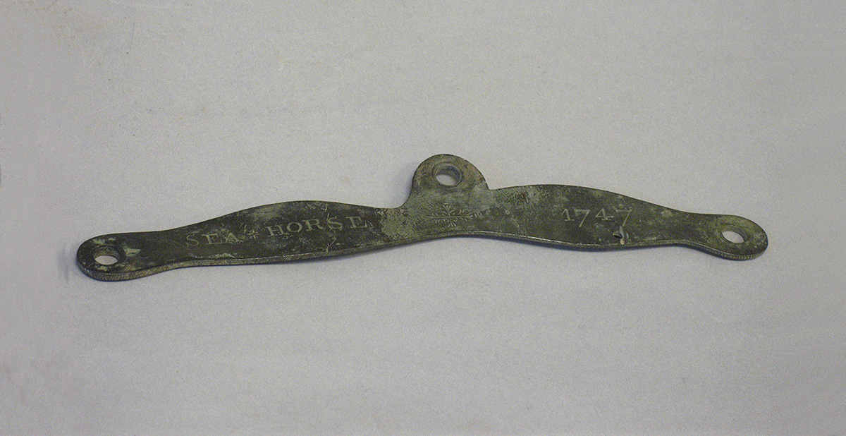 A small piece of metal on a white surface at the Canadian Museum of History.