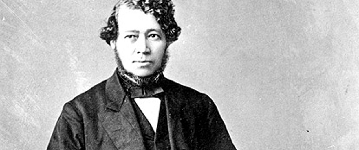 A black and white photo of a man in a suit at the Canadian Museum of History.