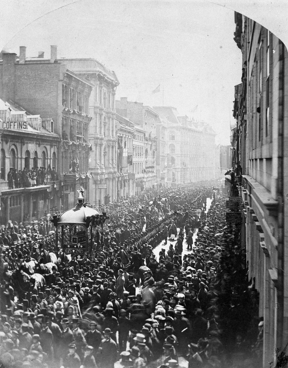 An old photograph of a crowd of people in a busy street, displayed at the Canadian Museum of History.