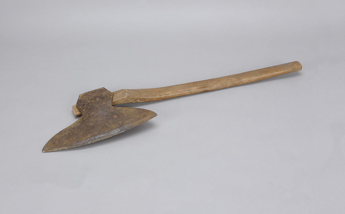 An axe with a wooden handle exhibited at the Canadian Museum of History.