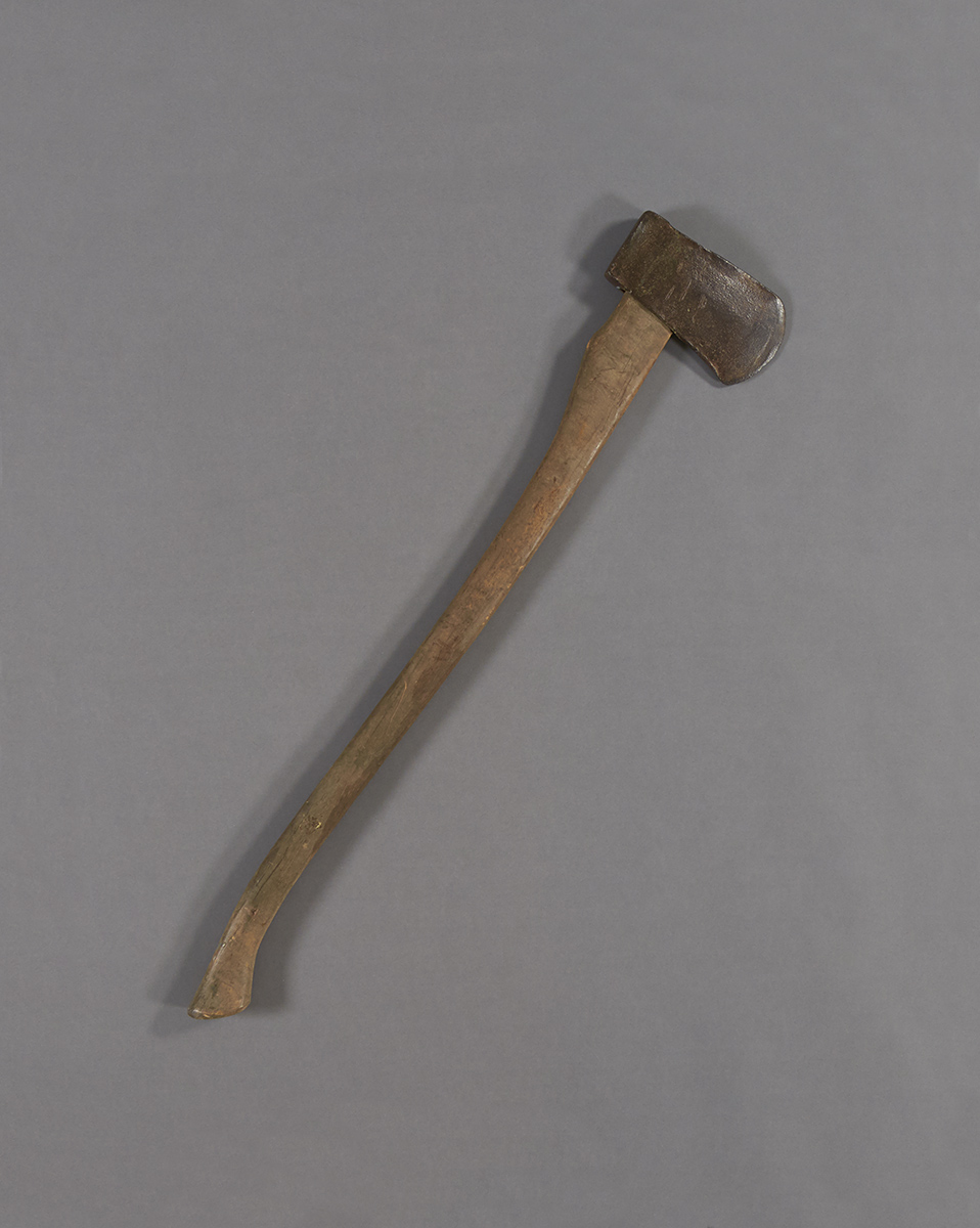 An old axe with a long wooden handle, displayed at the Canadian Museum of History in Ottawa.