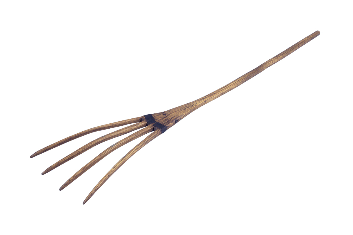 A wooden fork with a long handle, on display at the Canadian Museum of History in Ottawa.