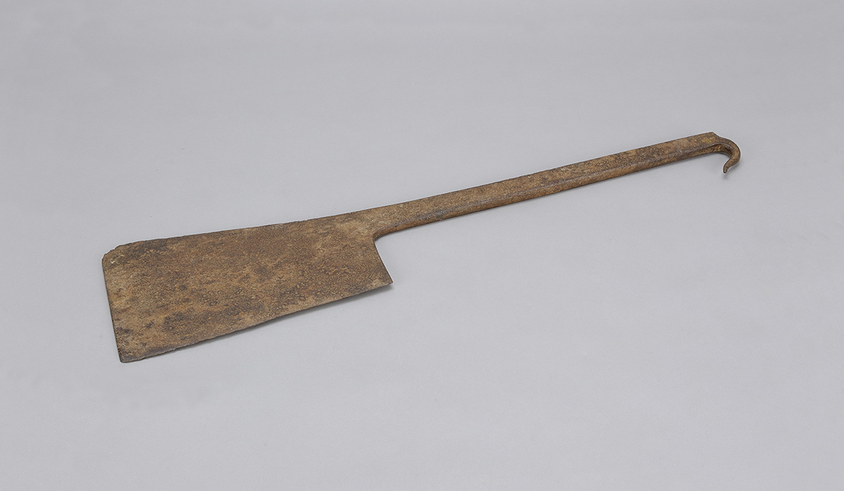 An old wooden axe on a gray background in Ottawa.