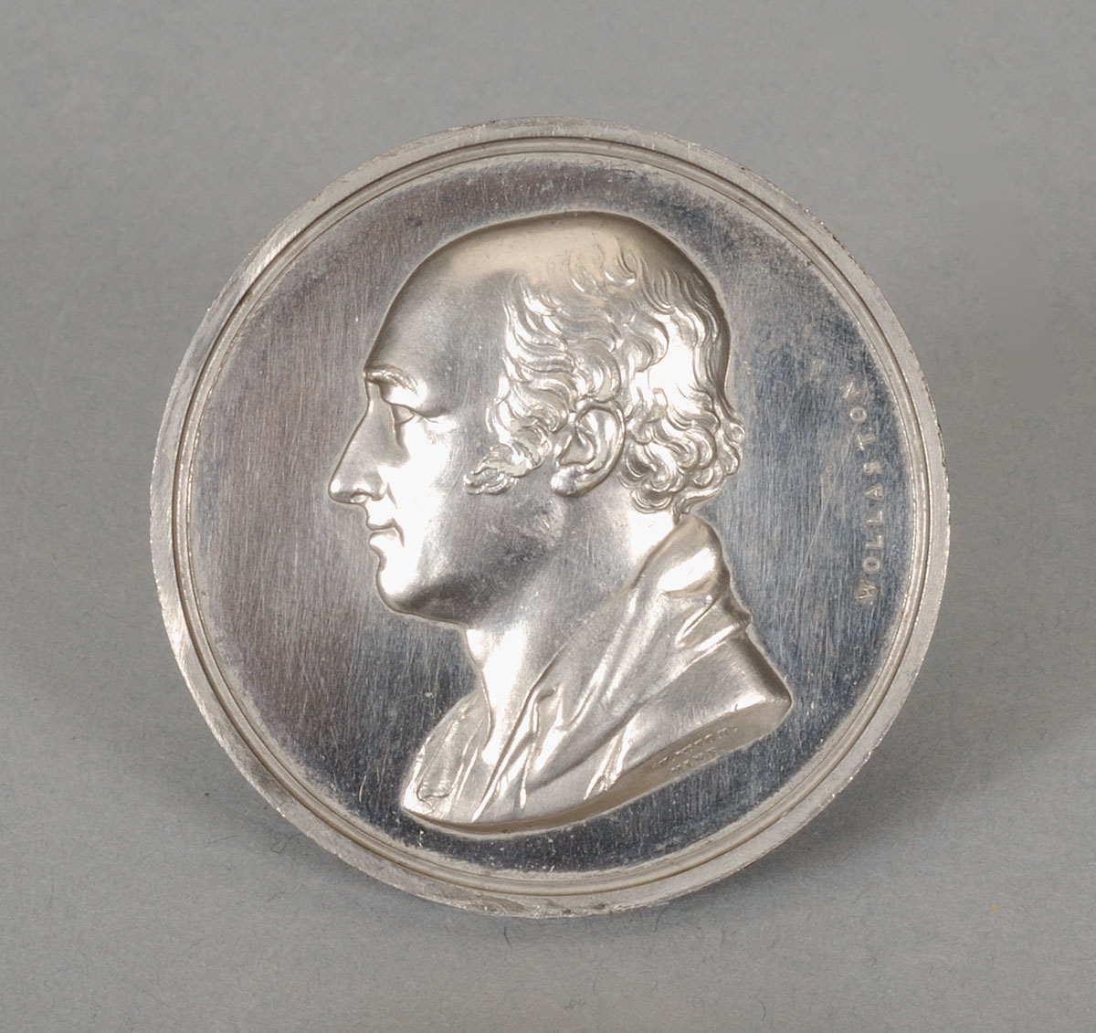 A silver coin with a portrait of a man on display at the Canadian Museum of History in Ottawa.