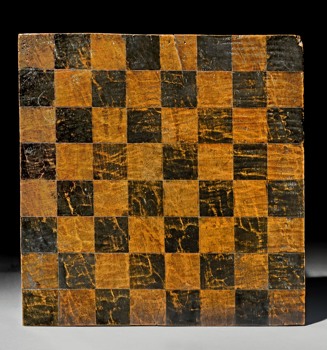 A chess board with black and brown squares on display at the Canadian Museum of History in Ottawa.