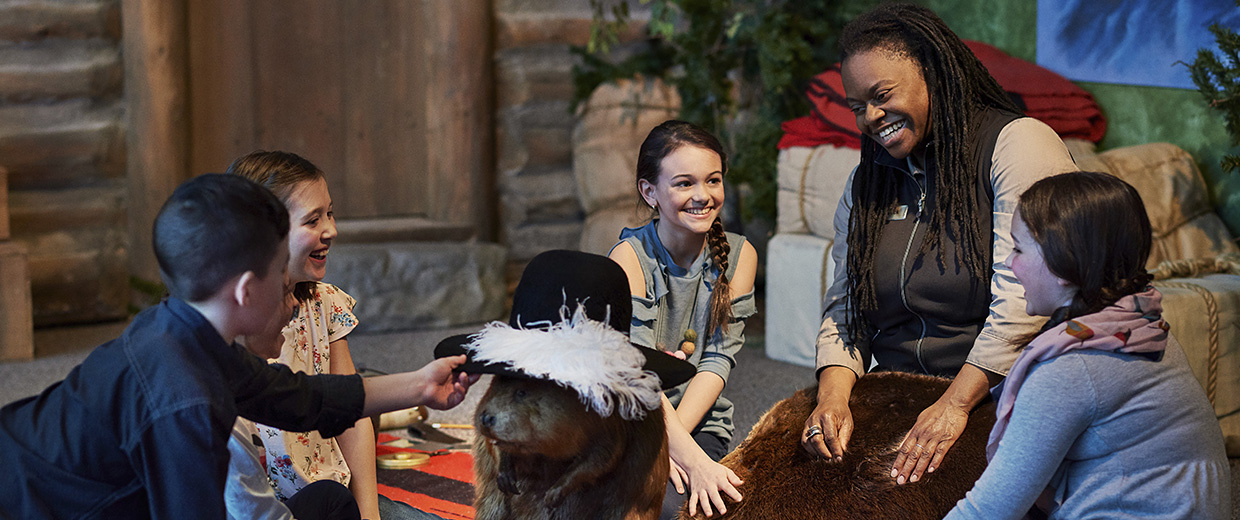 A group of children from Ottawa playing with a stuffed animal at the Canadian Museum of History.