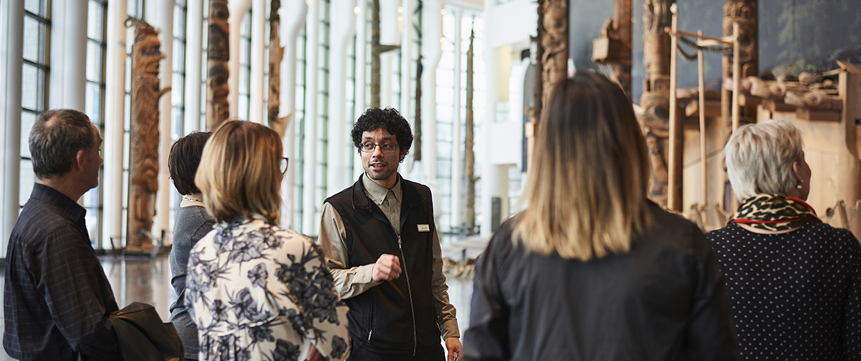 A group of people standing in the Canadian Museum of History lobby in Ottawa.