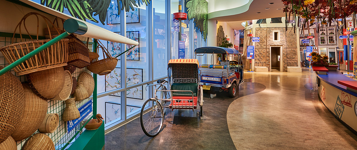 A room at the Canadian Museum of History in Ottawa with a lot of baskets and a tuk tuk.