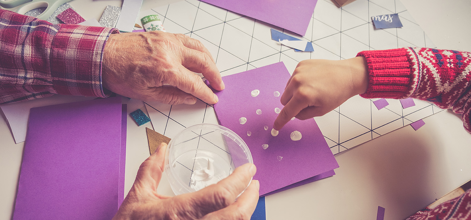 An older man and a child are making paper crafts at the Canadian Museum of History in Ottawa.