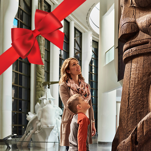 A woman and a child looking at a wooden sculpture at the Canadian Museum of History in Ottawa.