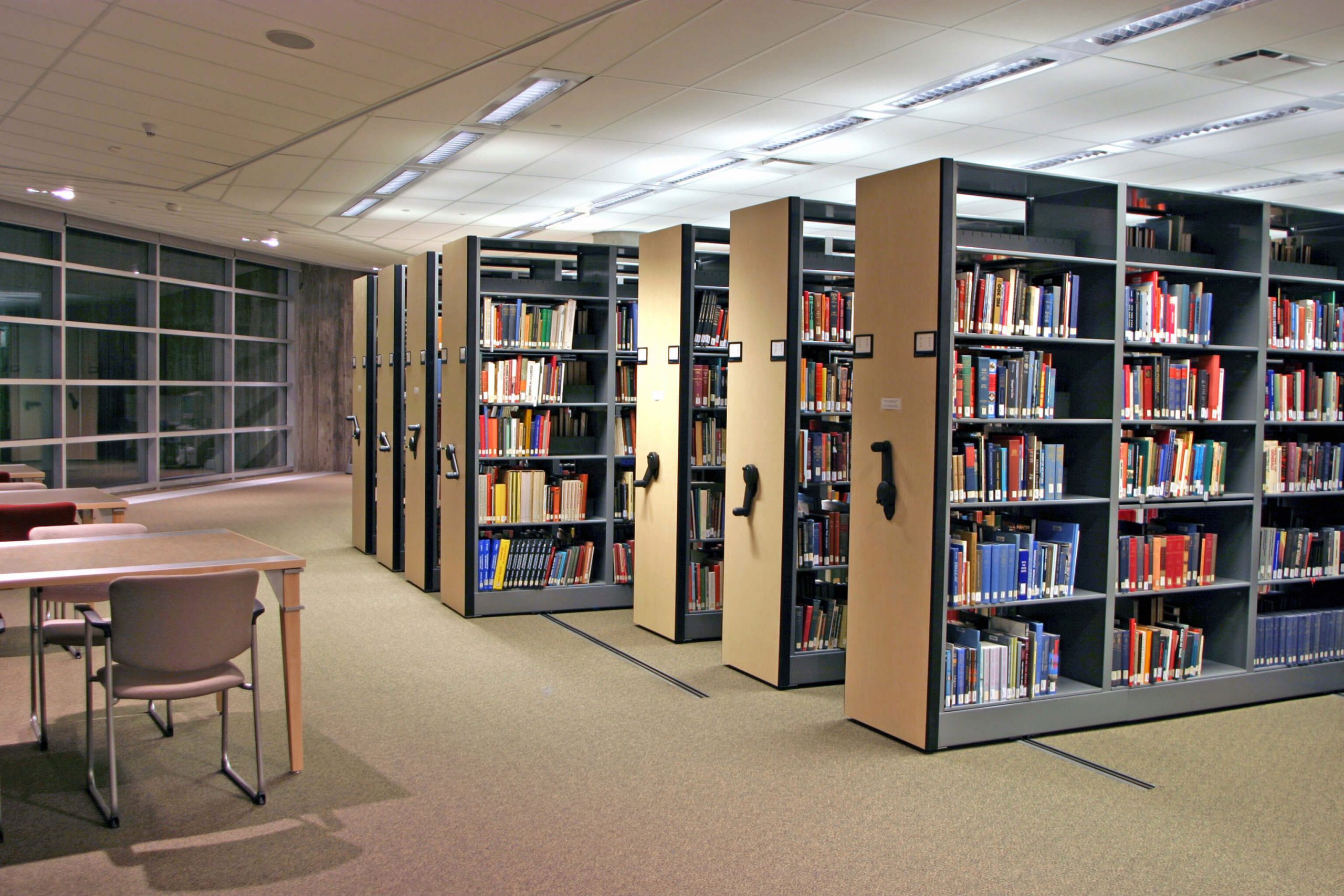 Rows of bookshelves in a library where a research team delves into knowledge.