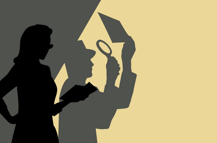 An unexpected silhouette of a woman holding a magnifying glass.