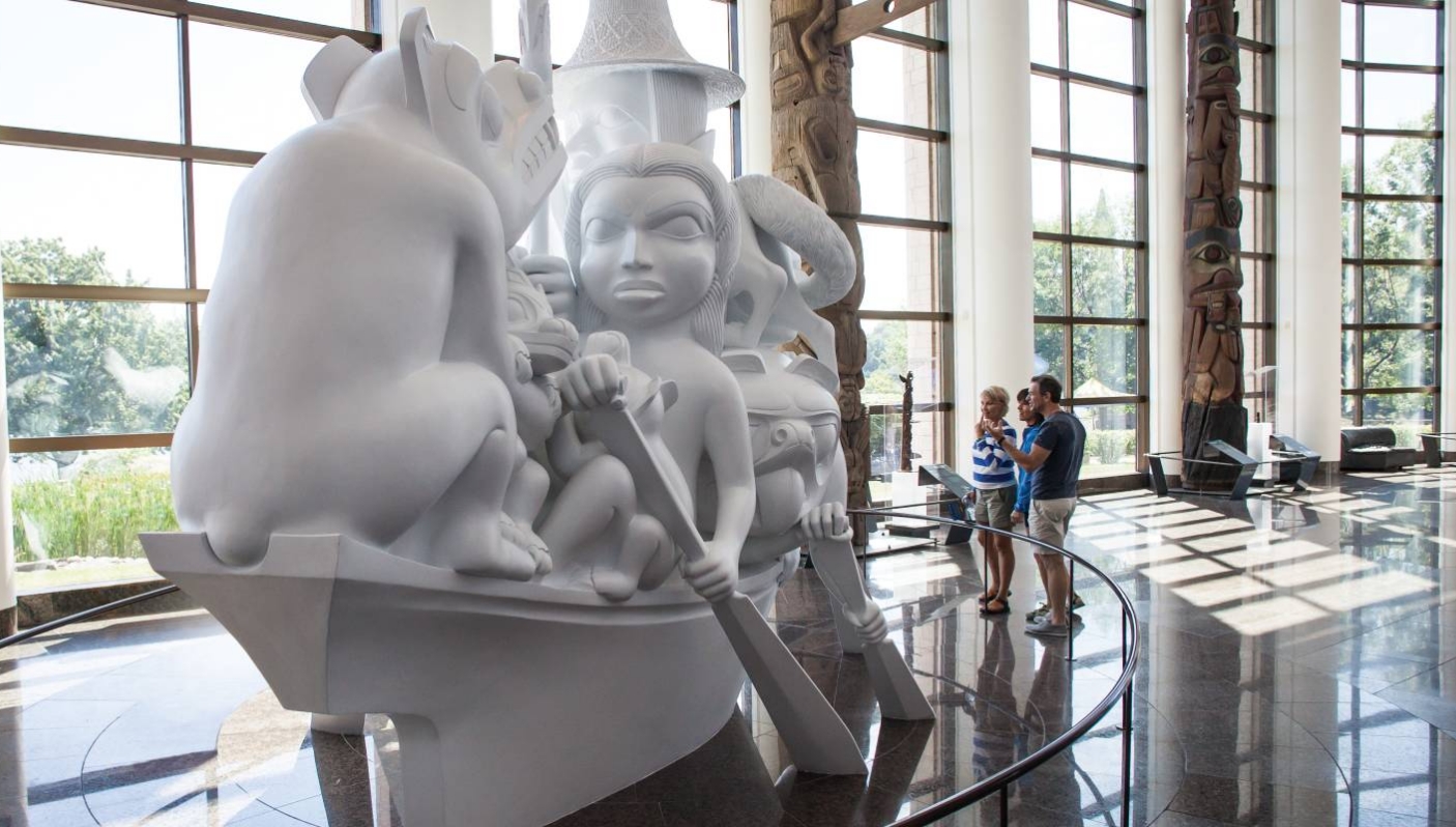 A group of people standing in front of a white sculpture at the Canadian Museum of History in Ottawa.