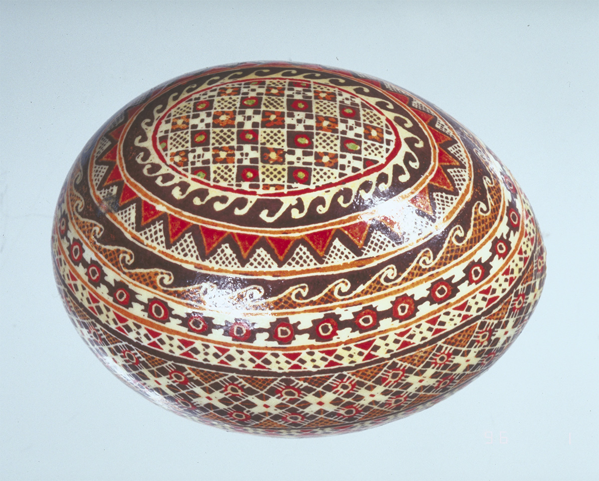 A wooden egg with a red and brown design on it, displayed at the Canadian Museum of History in Ottawa.