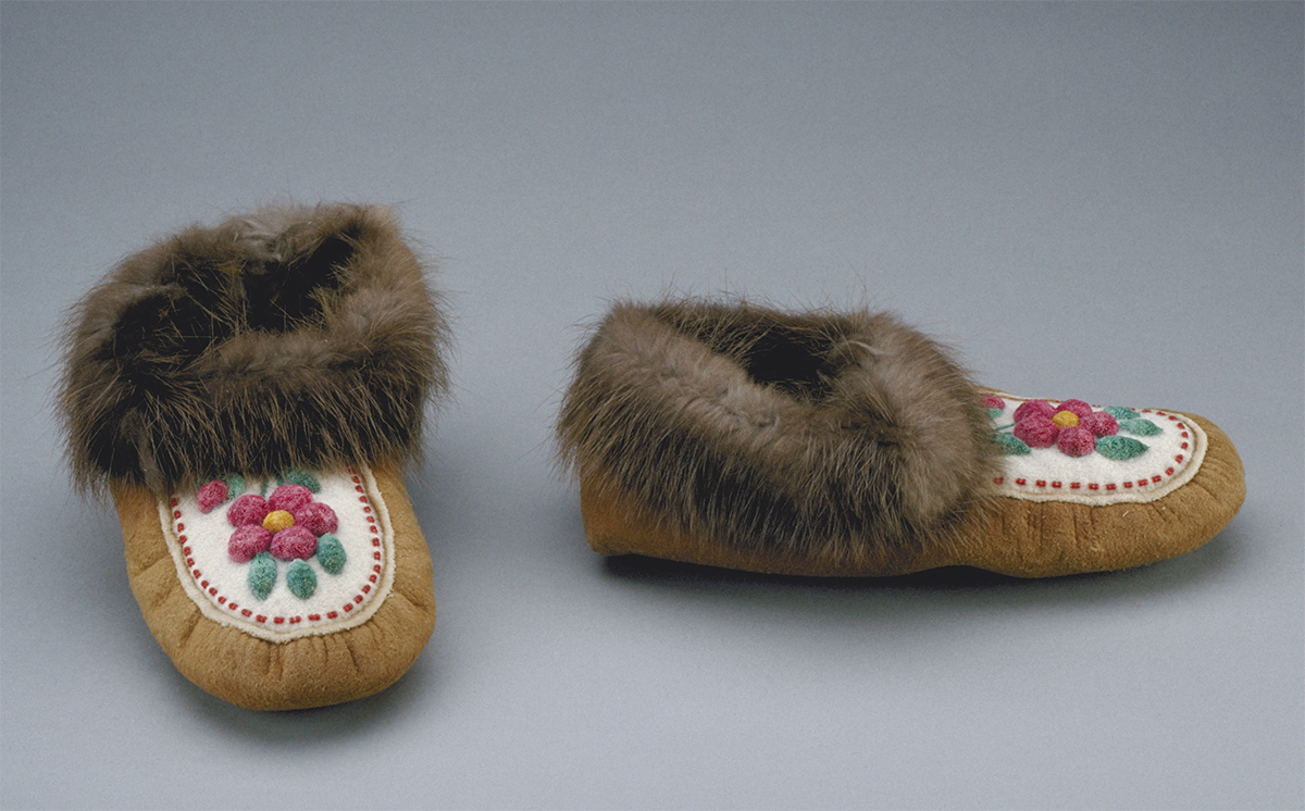 A pair of moccasins with fur and flowers exhibited at the Canadian Museum of History in Ottawa.