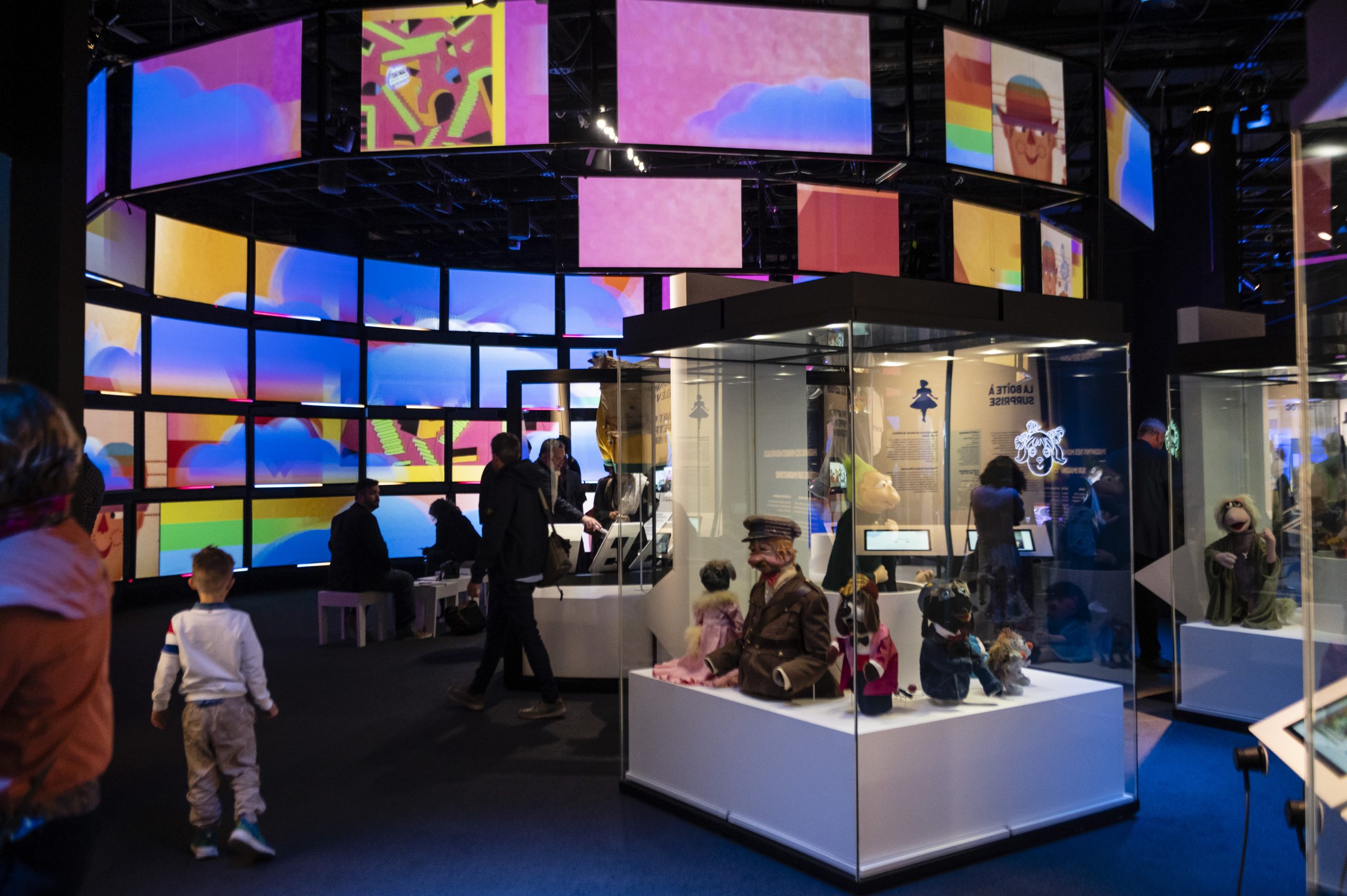 A group of people are standing in the Canadian Museum of History with colorful displays.