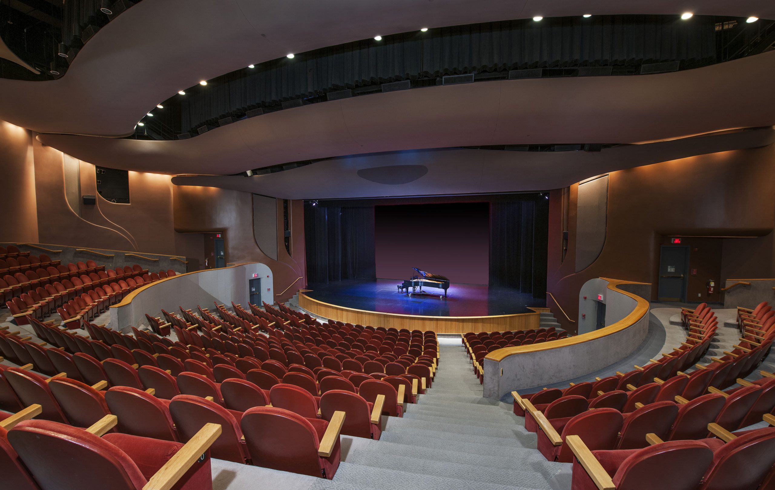 The Canadian Museum of History in Ottawa features an auditorium filled with red chairs and equipped with a piano.