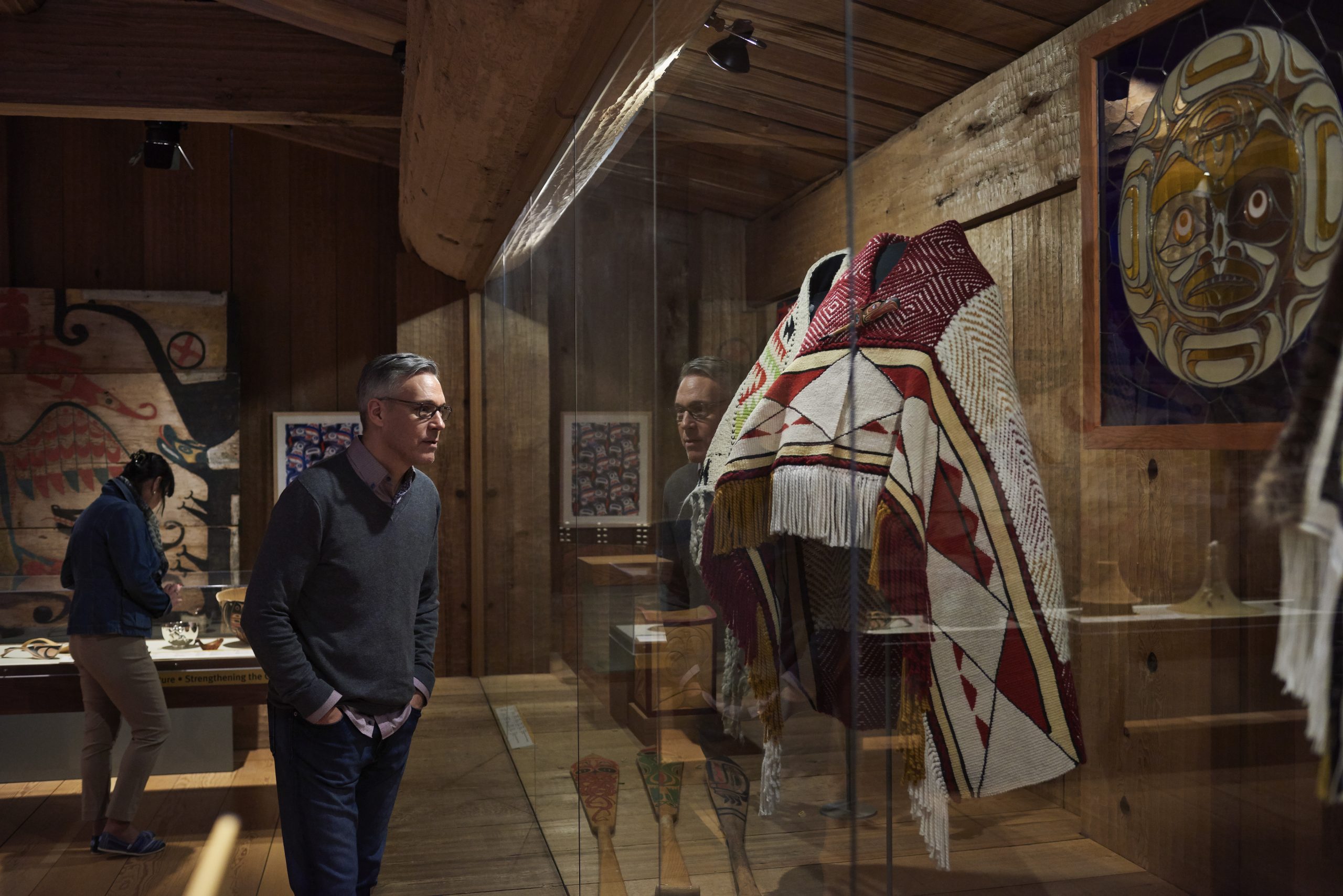 A man looking at a display of artifacts in the Canadian Museum of History in Ottawa.