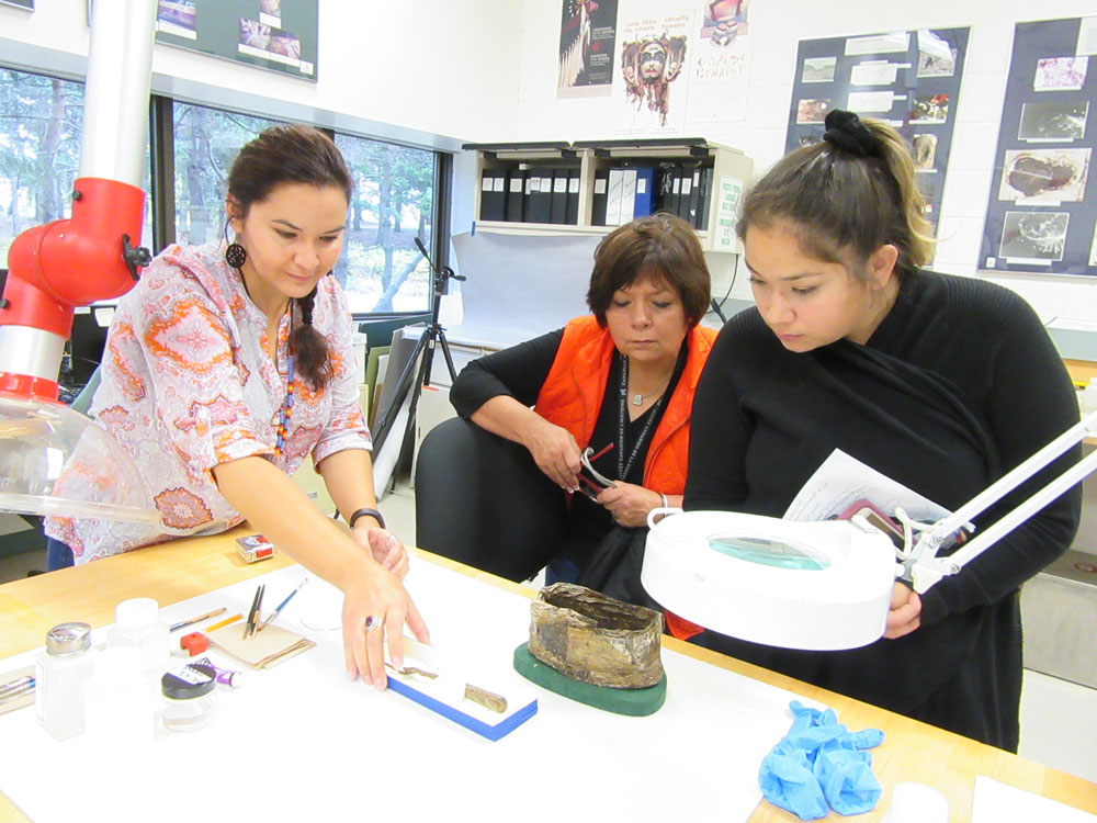 A group of women looking at an artifact in the Canadian Museum of History.