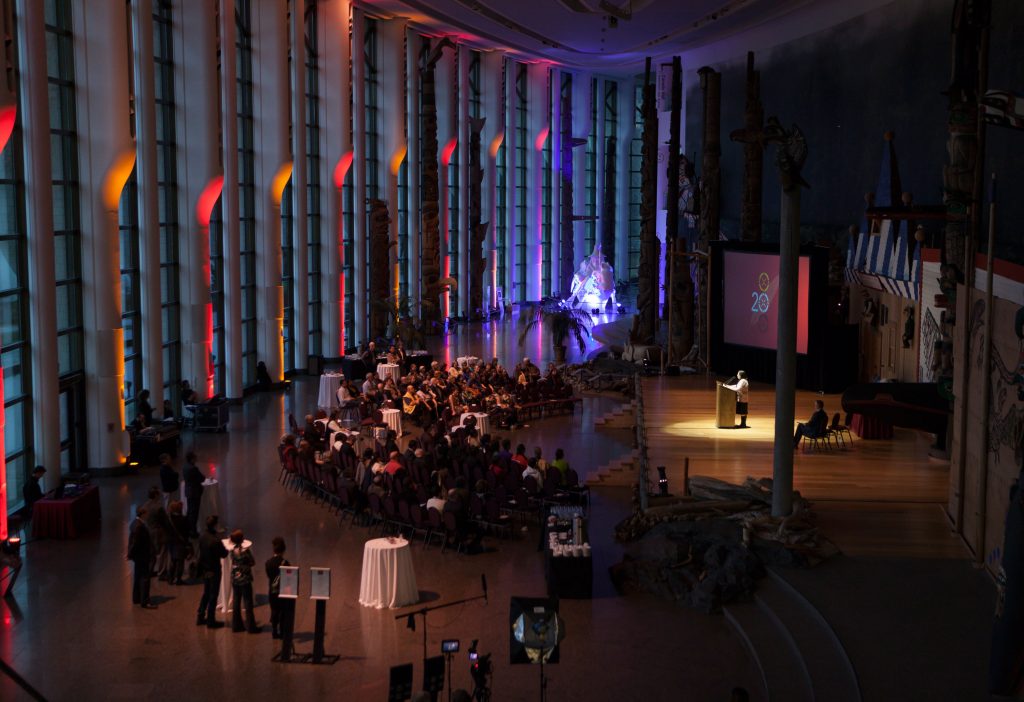 A large room filled with people at an event in Ottawa, held at the Canadian Museum of History.